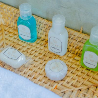 Bath products are neatly arranged in a woven basket.