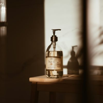 a bottle of soap sitting on top of a wooden table
